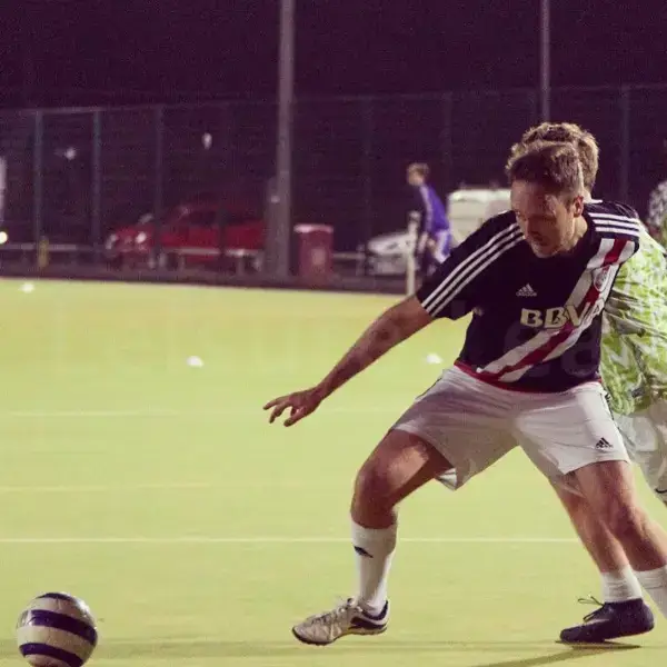 Owain shielding the ball from an opponent at five-a-side