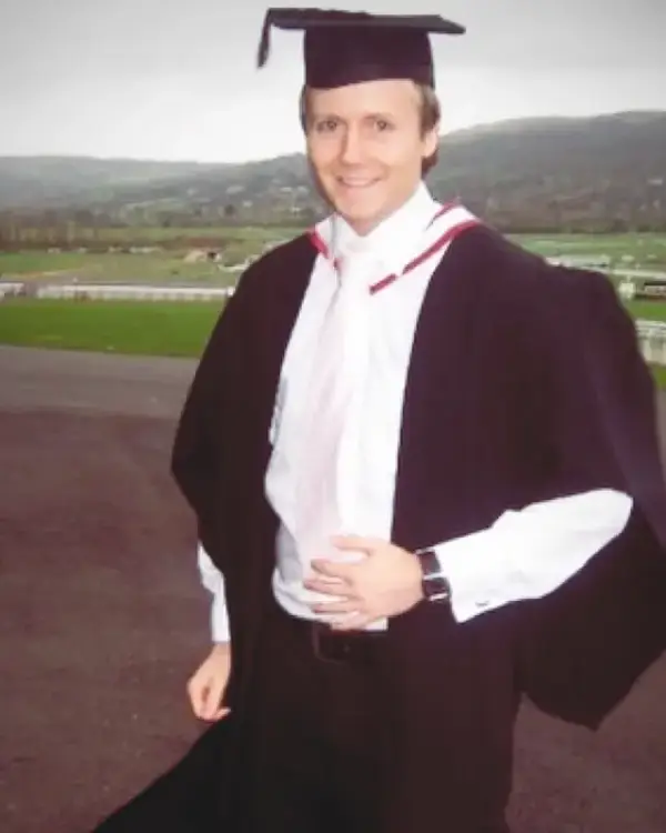 Owain in cap and gown at Cheltenham Racecourse on graduation day