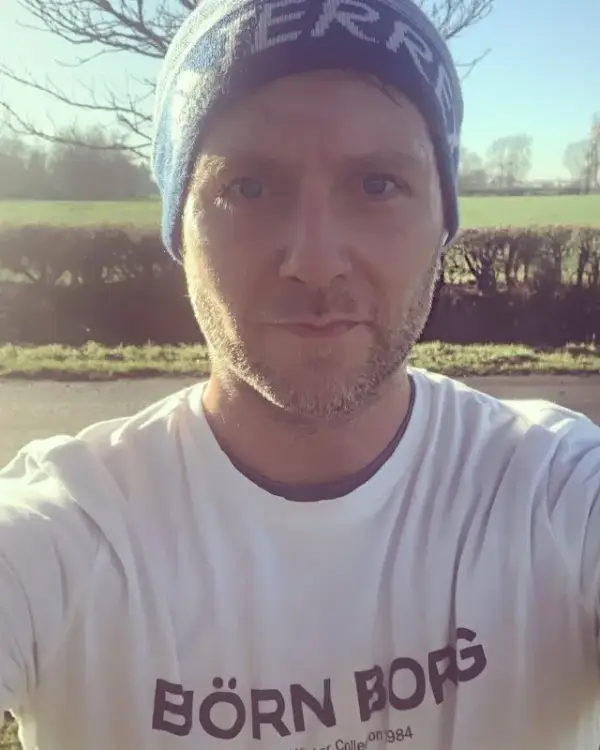 Owain in a beanie and running top, out on a winter training run