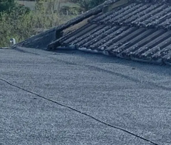 Old worn mineral felt flat roof