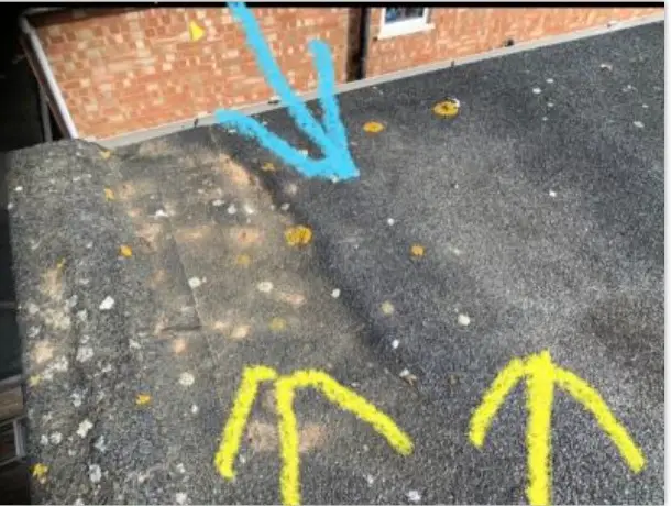 Arrows marking dips in the felt roof