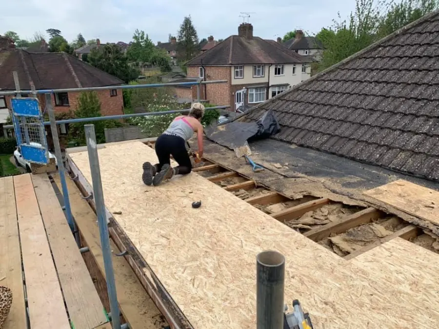 Roofer laying new OSB boards over roof joists