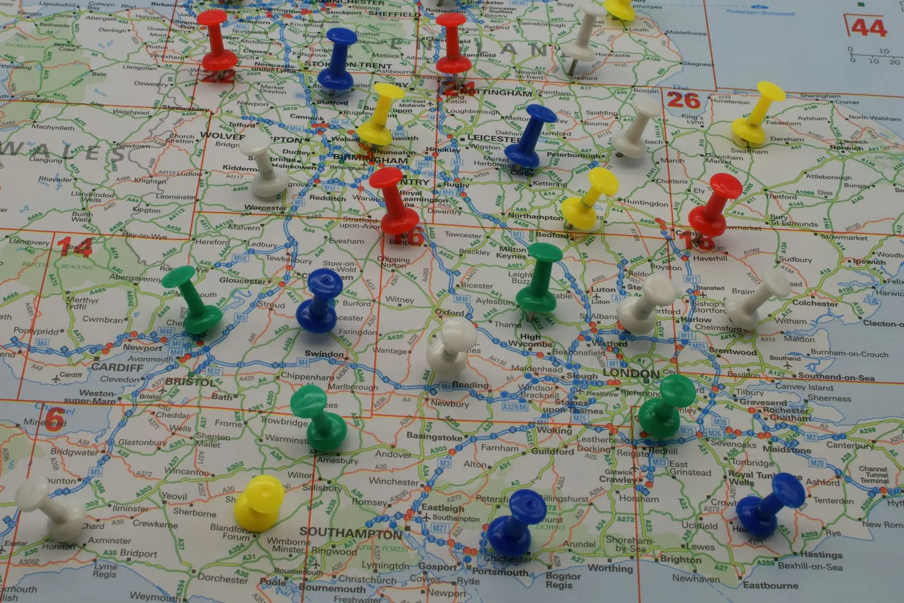 Coloured push pins across a road map of southern England