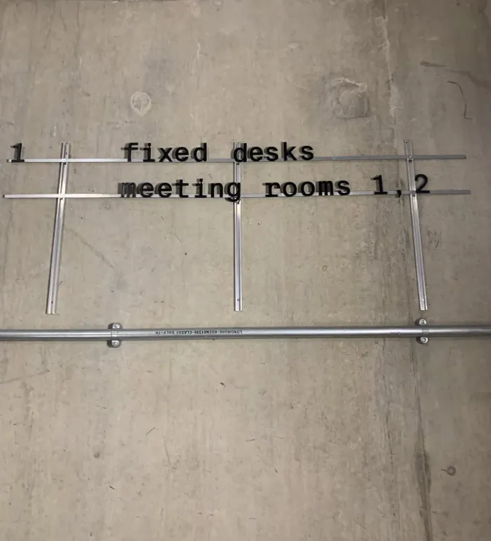 Sign for fixed desks and meeting rooms at Bureau Club